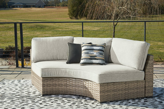 Calworth Curved Loveseat with Cushion Smyrna Furniture Outlet